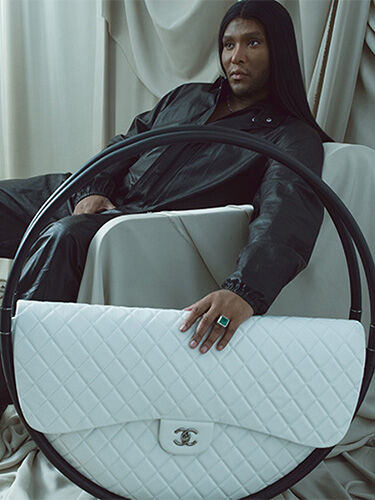 The Law Roach Edit: Law Roach with Chanel Hula Hoop XL Bag sitting on chair