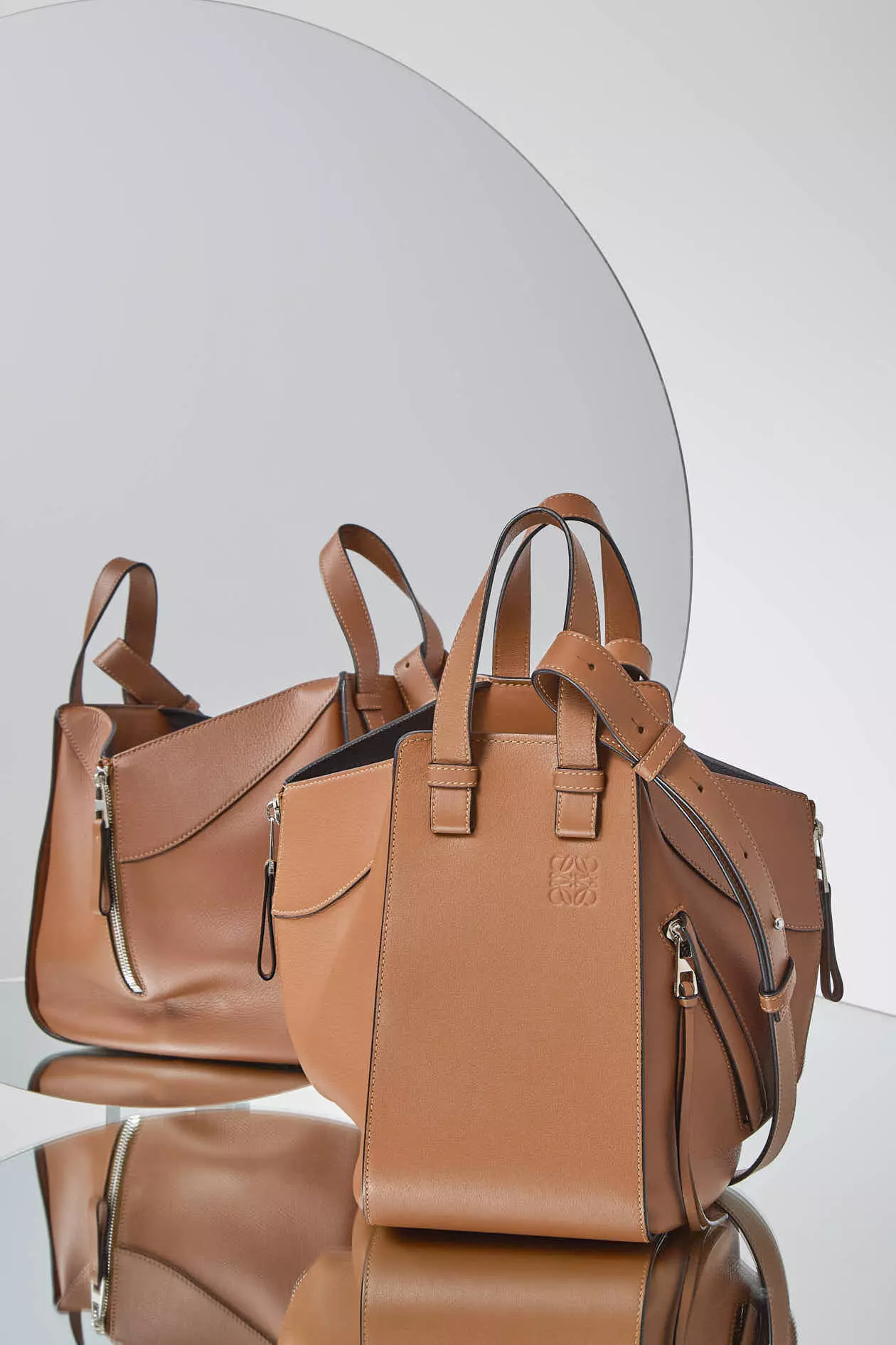 Shop by Brand: Loewe Brown Leather Drawstring Bag on a mirrored surface