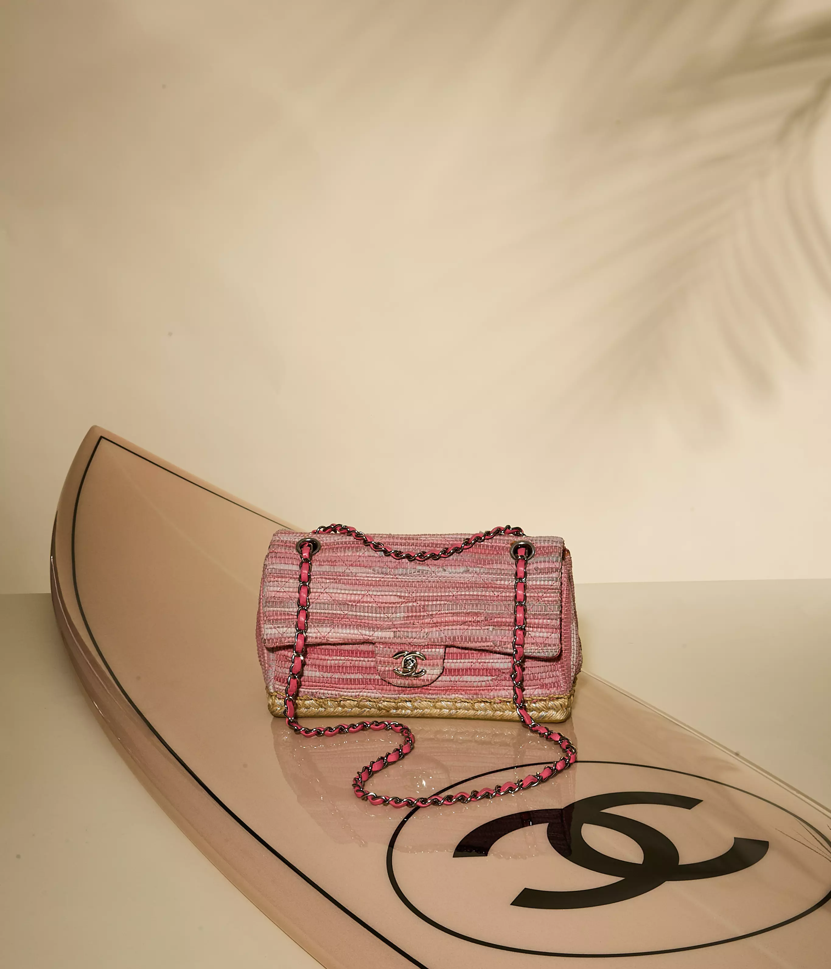 July Hero Banner: Chanel-inspired hero banner featuring a pink raffia handbag, layered pearl jewelry, and centered text reading &ldquo;Trending Now: Raffia&rdquo; with a &ldquo;Shop the Edit&rdquo; call to action.