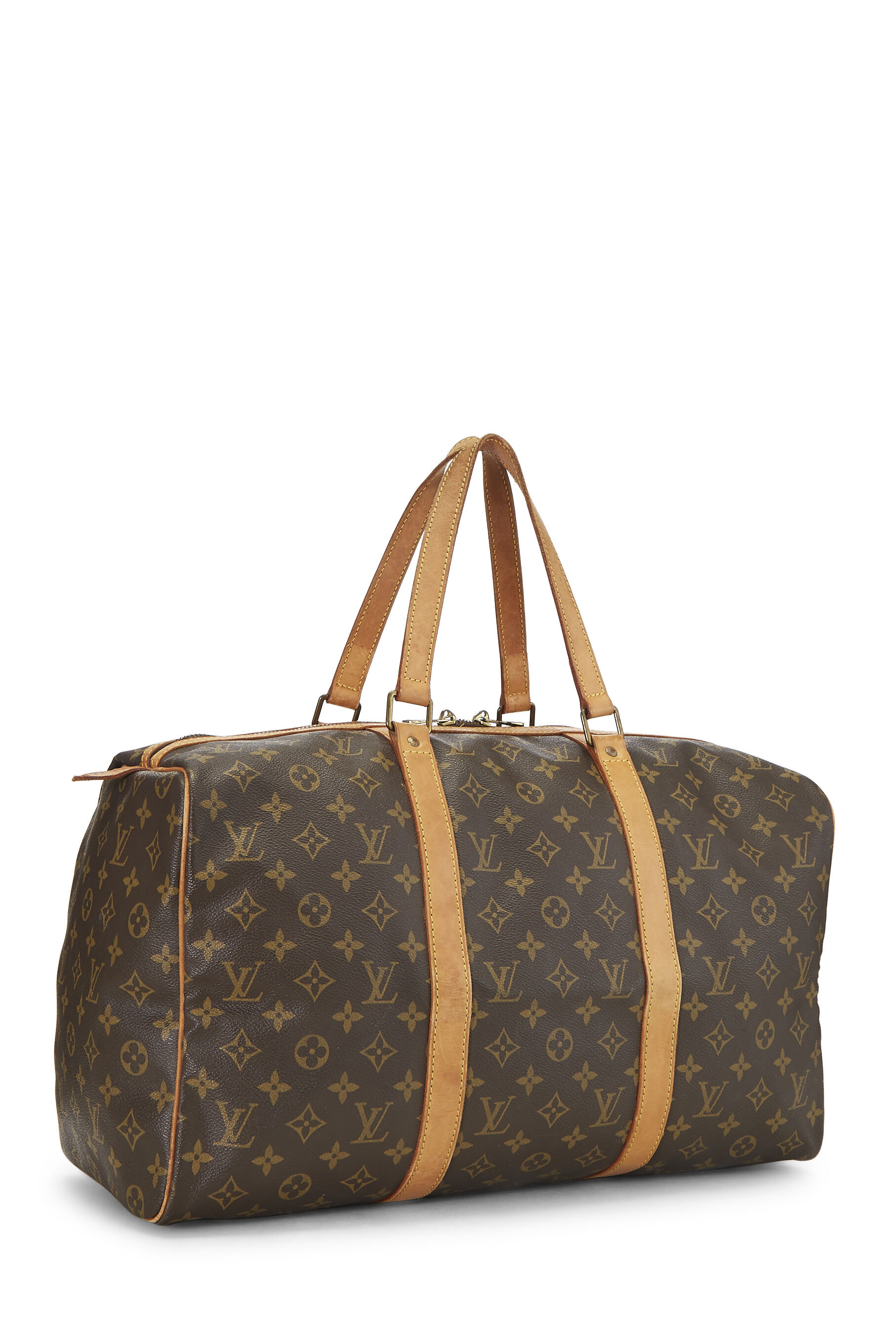 Sold at Auction: Louis Vuitton Sac Souple 45 Travel Bag, in a monogram  coated canvas, with vachetta leather accents and golden brass hardware, in  a b